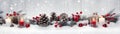 Red Christmas burning candles, balls, baubles and pine cones and branches in a row. Royalty Free Stock Photo