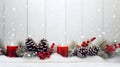 Red Christmas burning candles, balls, baubles and pine cones and branches. Royalty Free Stock Photo