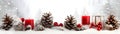 Red Christmas burning candles, balls, baubles and pine cones and branches. Royalty Free Stock Photo