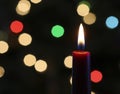 A Red Christmas Candle with Blurred Lights