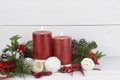 Red Christmas candle with potpourri elements and pine branches Royalty Free Stock Photo