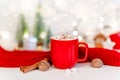 Red Christmas cocoa mug with marshmallow on a background with gingerbread. Copy space banner