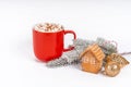 Red Christmas cocoa mug with marshmallow on a white background with gingerbread. Copy space banner.