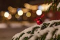 Red christmas decoration ball on a snowy tree Royalty Free Stock Photo