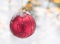 Red Christmas decoration globe on a pine tree with snow on the branches. Winter holidays postcard Royalty Free Stock Photo