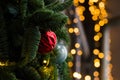 Red Christmas decoration with ornament on the pine with blurred yellow lights