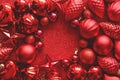 Red Christmas frame. Christmas balls, stars, cones and hearts on red sparkles background. Flat lay. Top view. Royalty Free Stock Photo