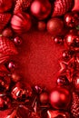 Red Christmas frame. Christmas balls, stars, cones and hearts on red sparkles background. Flat lay. Top view. Royalty Free Stock Photo