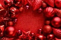 Red Christmas frame. Christmas balls, stars, cones and hearts on red sparkles background. Flat lay. Top view. Royalty Free Stock Photo