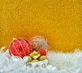 Christmas gift and baubles on golden background. Royalty Free Stock Photo