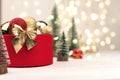 Red Christmas gift box with a gold bow and deer on the background of bokeh Royalty Free Stock Photo