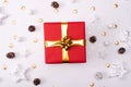 Red Christmas gift box with its lid propped at an angle in front to display the beautiful shiny metallic gold ribbon with falling Royalty Free Stock Photo