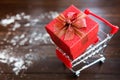 Red Christmas gift on cart with snow Royalty Free Stock Photo