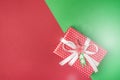 Red Christmas Gift Box on Red Green Background With Copy Space Top View Royalty Free Stock Photo