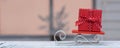Red Christmas gift box on wooden sledges against the background of the Christmas window. Happy New Year and Merry Christmas!Banner