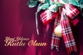 Red christmas gift ribbon on red background with text. Yeni yiliniz kutlu olsun means happy new year