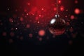 Red Christmas glass ball hanging on blurred black snowy background with bokeh golden lights. Royalty Free Stock Photo