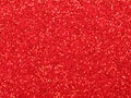 Red christmas glitter background with stars. Festive glowing blurred texture