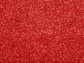 Red christmas glitter background with stars. Festive glowing blurred texture