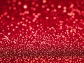 Red christmas glitter background with stars. Festive glowing blurred texture