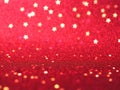 Red christmas glitter background with stars. Festive glowing blurred texture