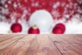 red christmas holiday background with empty wooden deck table over winter bokeh Royalty Free Stock Photo