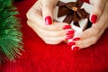 Red Christmas manicure make in beauty studio on Christmas background Royalty Free Stock Photo