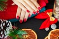 Red Christmas manicure make in beauty studio on Christmas background Royalty Free Stock Photo