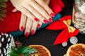 Red Christmas manicure make in beauty studio on Christmas background Royalty Free Stock Photo