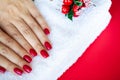 Red Christmas manicure make in beauty studio on Christmas background Royalty Free Stock Photo