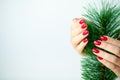 Red Christmas manicure make in beauty studio on Christmas background Royalty Free Stock Photo