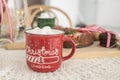 red Christmas mug with cocoa and marshmallows. on the table with Christmas cake. Christmas. New Year.