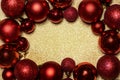 Red Christmas and New year background with christmas bauble frame on golden glitter texture with copyspace. Clean elegant minimal Royalty Free Stock Photo