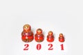 Red christmas numbers 2021 combined with russian nesting dolls on isolated white background. russian doll matryoshka Holiday Royalty Free Stock Photo