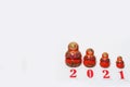 Red christmas numbers 2021 combined with russian nesting dolls on isolated white background. russian doll matryoshka Holiday Royalty Free Stock Photo