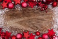 Red Christmas ornament double border with snow on rustic wood Royalty Free Stock Photo