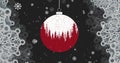 A red Christmas ornament with a snowy scene