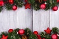 Red Christmas ornaments and branches double border on white wood