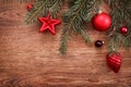 Red Christmas ornaments and fir tree branch on a rustic wooden background. Xmas card. Happy New Year. Top view Royalty Free Stock Photo