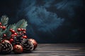 Red Christmas ornaments, holly berries, cones and fir tree branches on dark wooden table. Christmas background with copy space Royalty Free Stock Photo