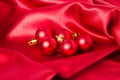 Red Christmas ornaments on red silk Royalty Free Stock Photo