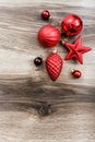 Red Christmas ornaments on a rustic wooden background. Xmas card. Happy New Year. Top view Royalty Free Stock Photo