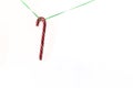 Red Christmas pendant decorative lollipop with green rope isolated on white background