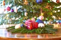 Red christmas present and baubles, Christmas tree Royalty Free Stock Photo