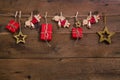 Red christmas presents with golden angels hanging on an old wood