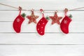 Red Christmas socks and stars on white wooden background. Copy s Royalty Free Stock Photo