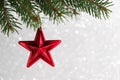 Red christmas stars on the xmas tree on glitter bokeh background. Royalty Free Stock Photo