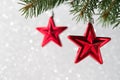 Red christmas stars on the xmas tree on glitter bokeh background. Merry christmas card. Royalty Free Stock Photo