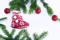 Red Christmas stocking sock and decoration balls on white background, frame of green contiferous tree branches Royalty Free Stock Photo