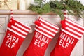 Red Christmas stockings hanging on decorated fireplace Royalty Free Stock Photo